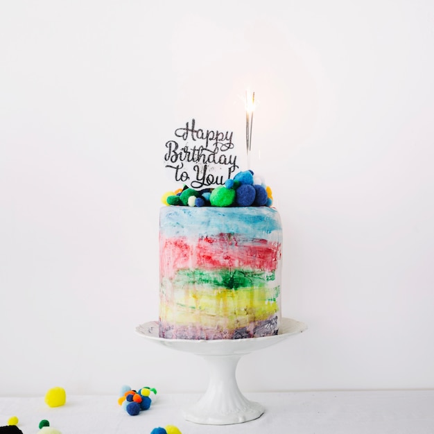 Colorful cake with writing and sparklers