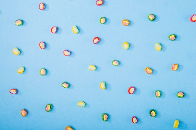 Colorful candies on blue background