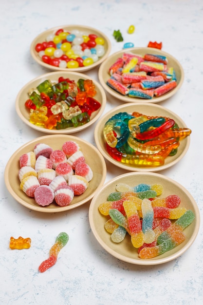 Colorful candies, jelly,marshmallow on light surface. Top view with copy space