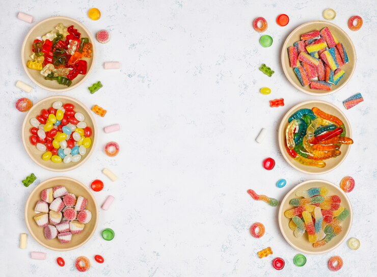 Free Photo colorful candies, jelly,marshmallow on light surface. top view with copy space