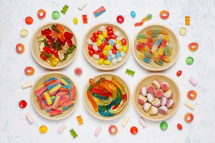 Free Photo colorful candies, jelly,marshmallow on light surface. top view with copy space