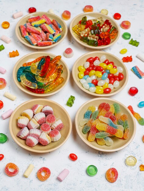 Colorful candies, jelly,marshmallow on light surface. Top view with copy space