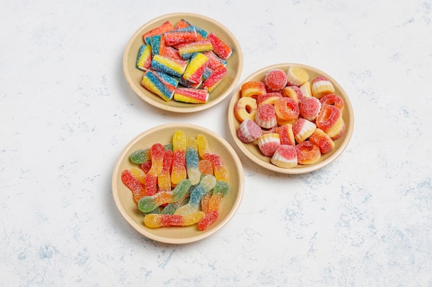 Colorful candies, jelly,marshmallow on light surface. Top view with copy space