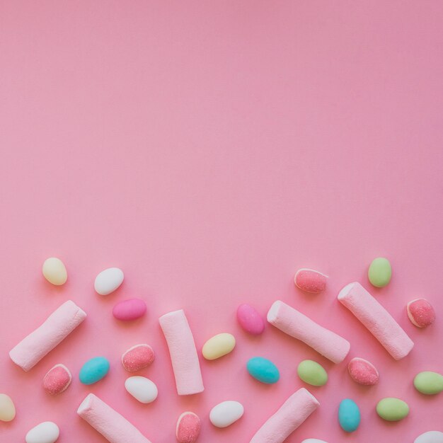 Colorful candies and marshmallows with copy space