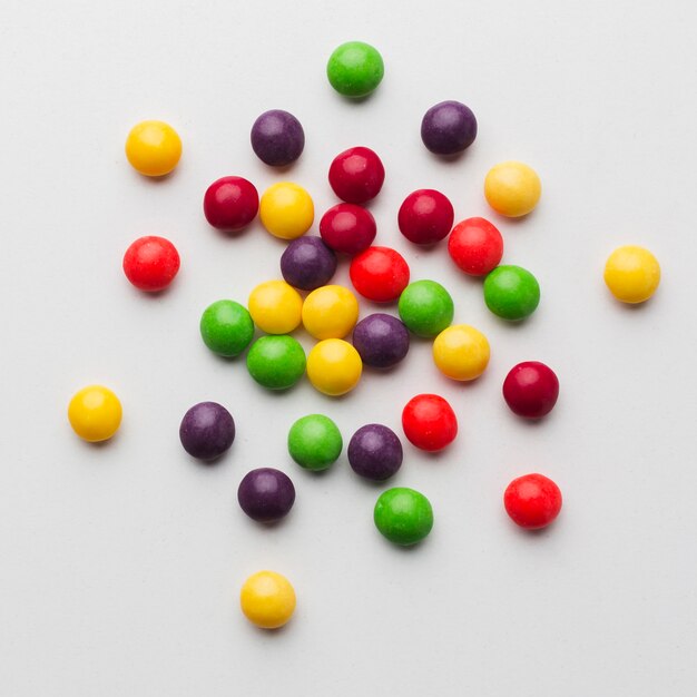 Colorful candies on white table