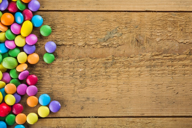 Colorful candies on wooden background