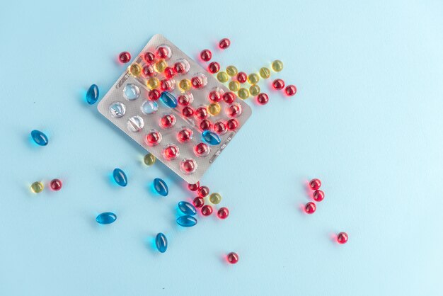 Colorful capsules and pills packed in blisters