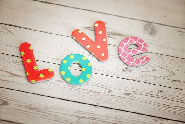 colorful cardboard letters spelling out "Love"