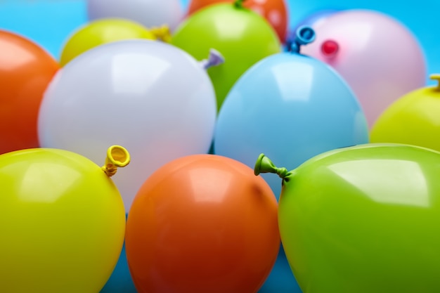 Colorful celebration fun balloons on blue background.