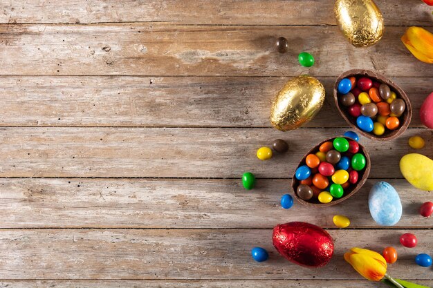 Colorful chocolate Easter eggs on wooden table