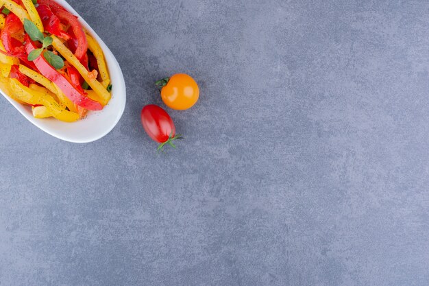 Colorful chopped pepper salad with cherry tomatoes