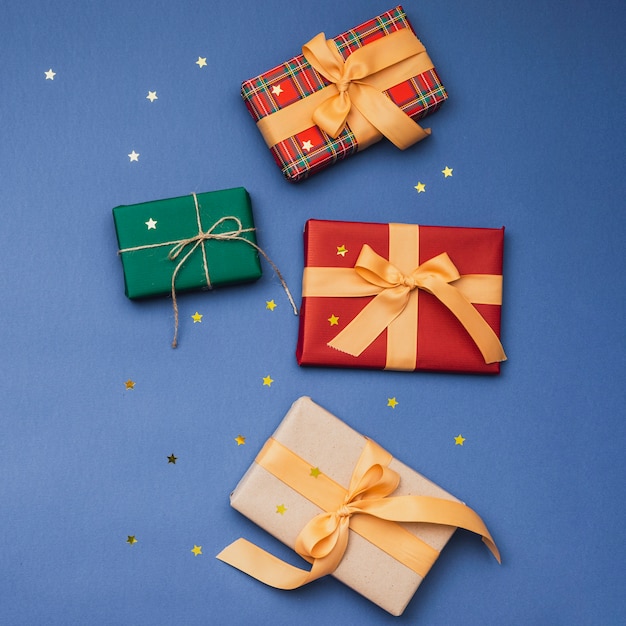 Colorful christmas gifts with ribbon and golden stars