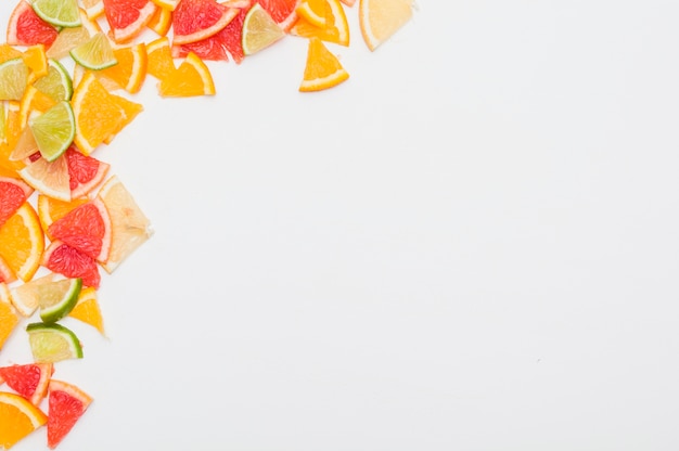 흰색 배경 모서리에 다채로운 감귤류 과일 조각