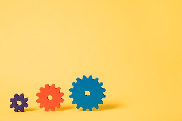 Colorful cogwheels with yellow background