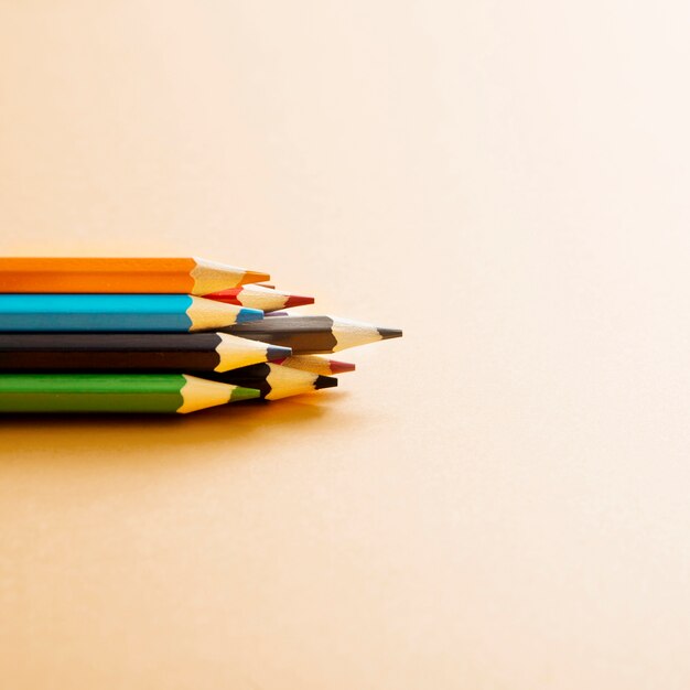 Colorful colored pencil on beige background