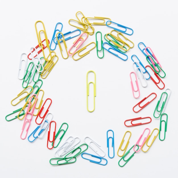 Colorful composition of paper clips on white background