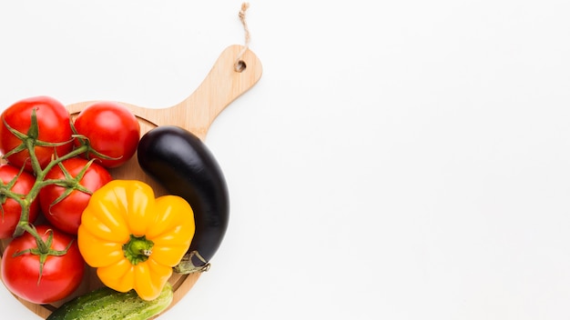 Colorful composition of vegetables on wooden board