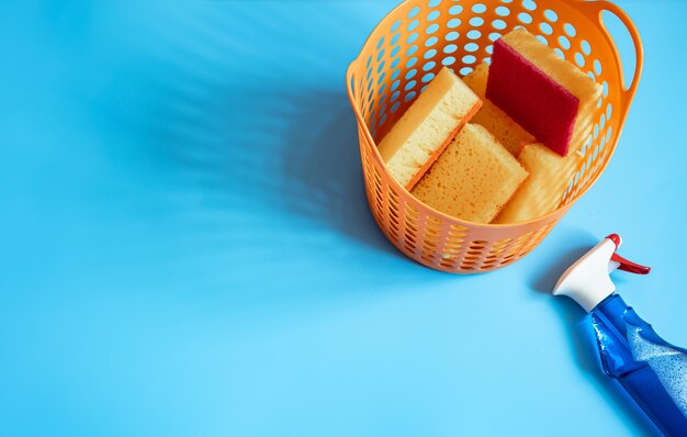 Colorful composition with a set of bright cleaning sponges and cleaning agent. Cleaning service concept  background
