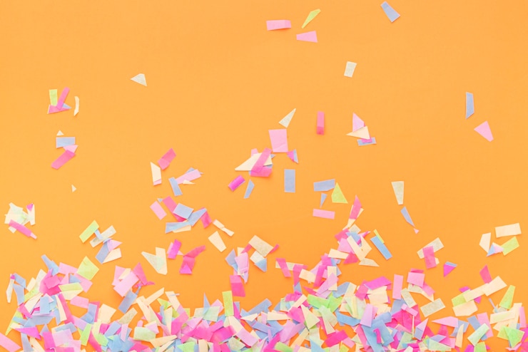 Free Photo colorful confetti on a orange background