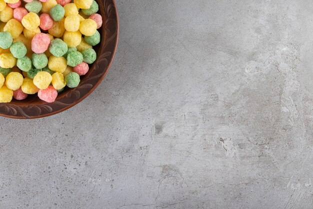 Colorful corn ball in a bowl, on the marble table.