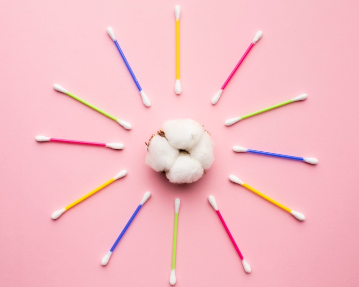 Free Photo colorful cotton buds surrounding cotton balls