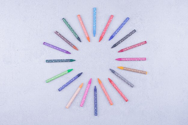 Colorful crayons isolated on grey surface