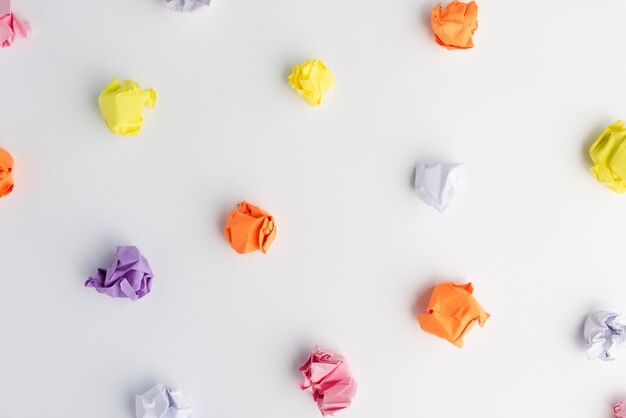 Colorful crumpled paper ball on white background