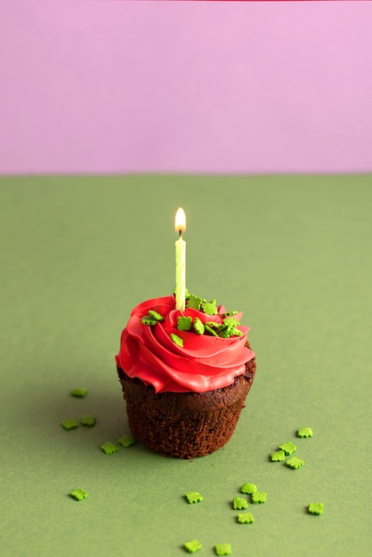 Colorful delicious cupcake with frosting on top