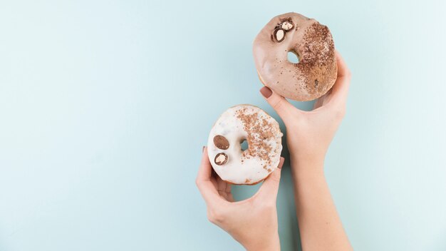 Colorful donuts with hands