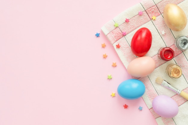 Colorful easter egg painted in pastel colors composition with paint brush