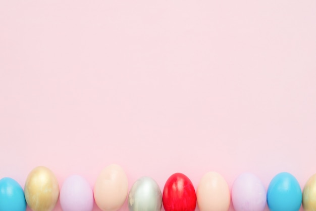 Colorful easter egg painted in pastel colors composition with paint brush