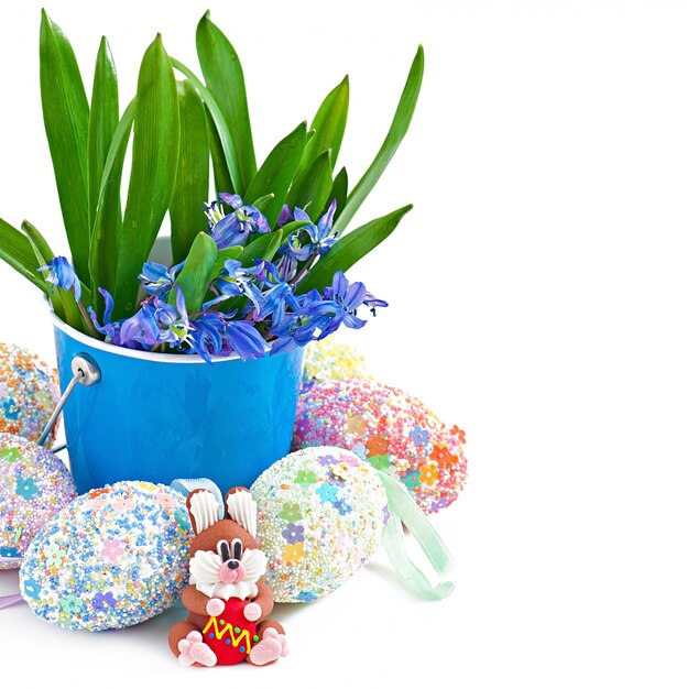 Colorful Easter eggs in a basket on a white