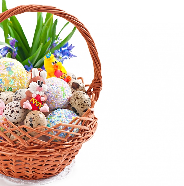 Colorful Easter eggs in a basket on a white