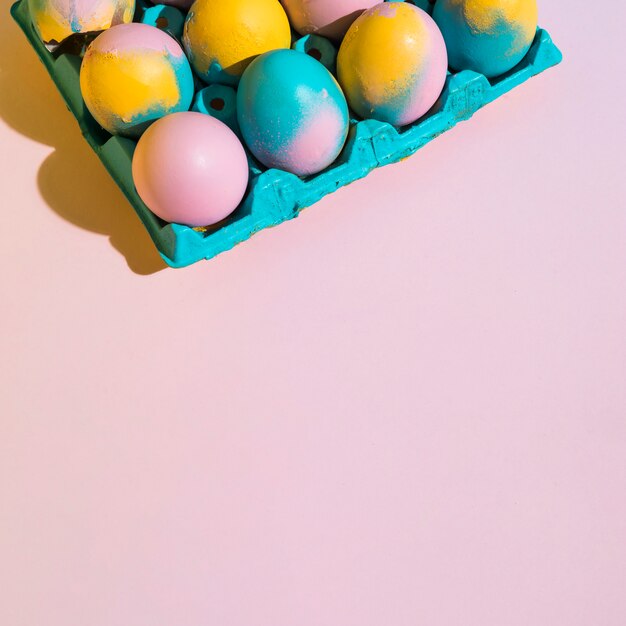 Colorful Easter eggs in bright rack on table