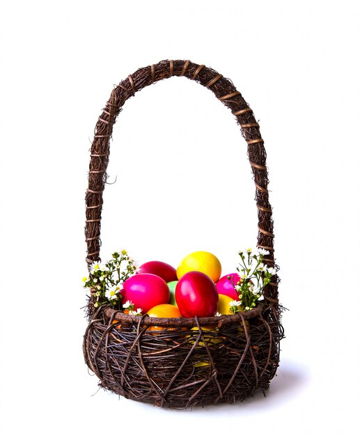 Colorful easter eggs in brown basket