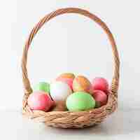 Free photo colorful easter eggs in hay basket front view