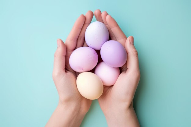 Colorful Easter eggs holding hands on turquoise background