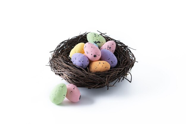 Colorful Easter eggs inside a nest isolated on white background