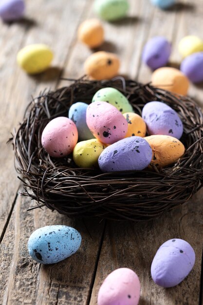 Colorful Easter eggs inside a nest on wooden table