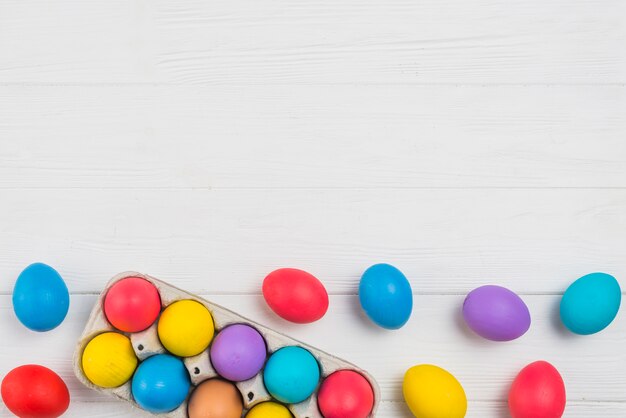 Colorful Easter eggs in rack on light table