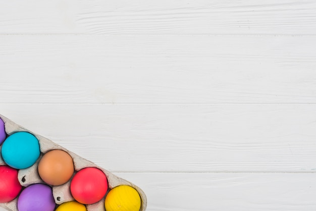 Free photo colorful easter eggs in rack on table