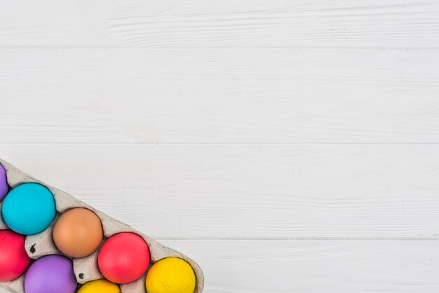 Colorful Easter eggs in rack on table