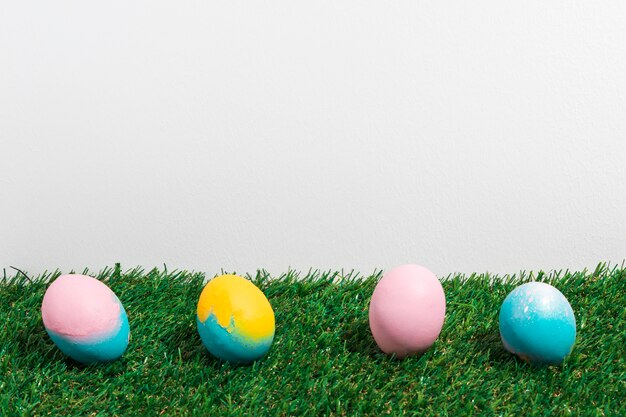 Colorful Easter eggs scattered on grass