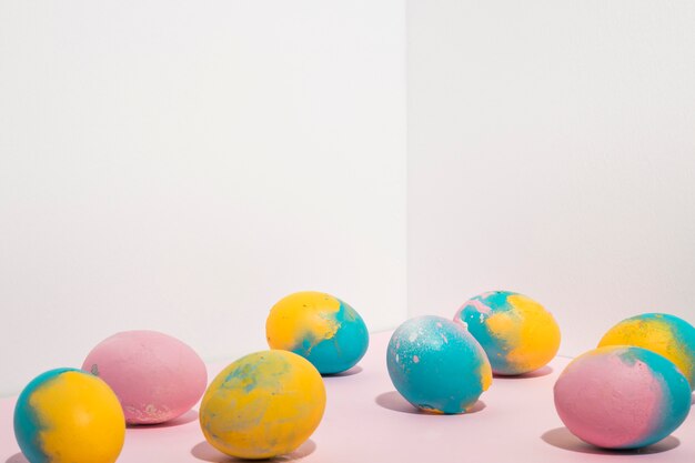 Colorful Easter eggs scattered on light table