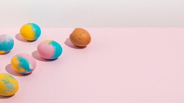 Colorful Easter eggs scattered on table