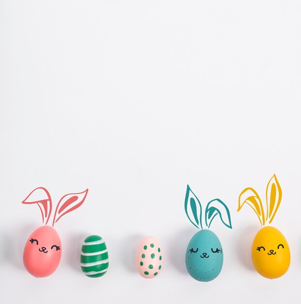 Colorful easter eggs on white background top view