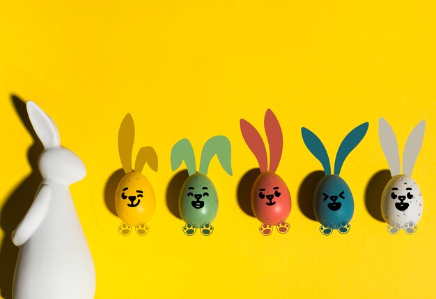 Colorful easter eggs on yellow background