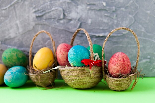 Colorful eggs in baskets