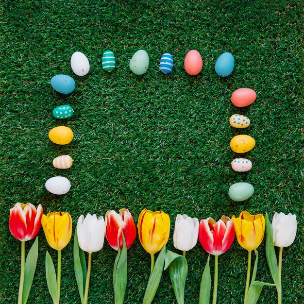 Colorful eggs and tulips in composition