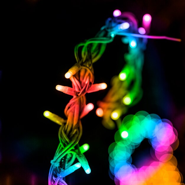 Colorful fairy light and bokeh ring against black background